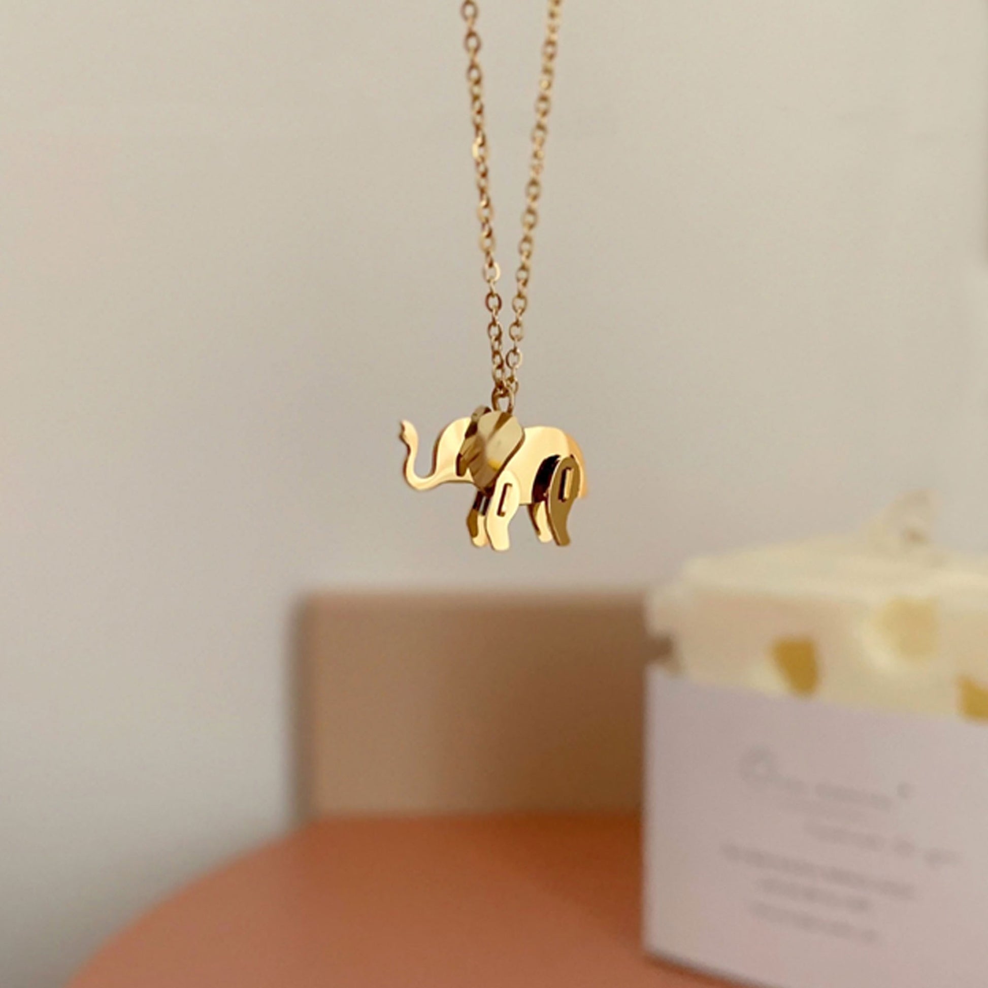 Golden elephant necklace in the air