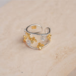 Adjustable osmanthus ring displayed on neutral background