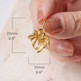 Boutique gold floral earrings close-up