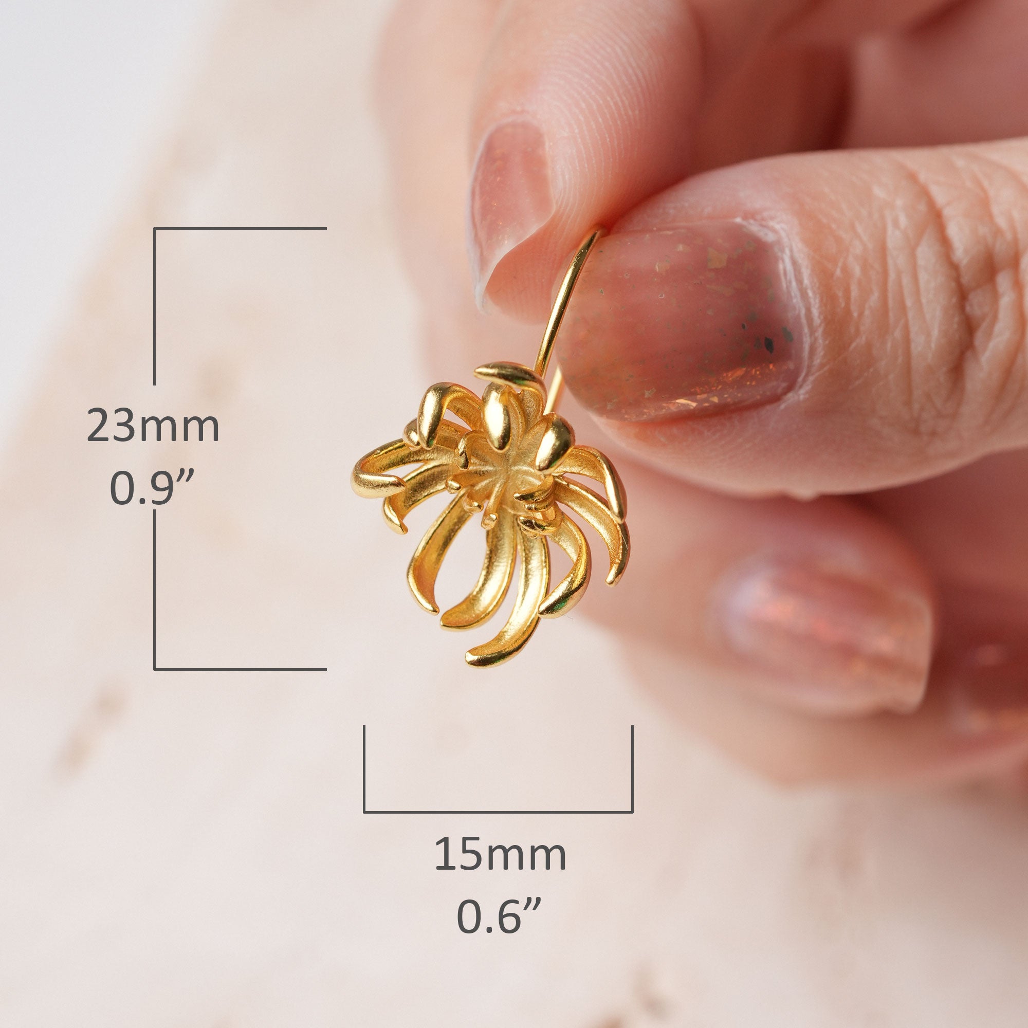 Boutique gold floral earrings close-up
