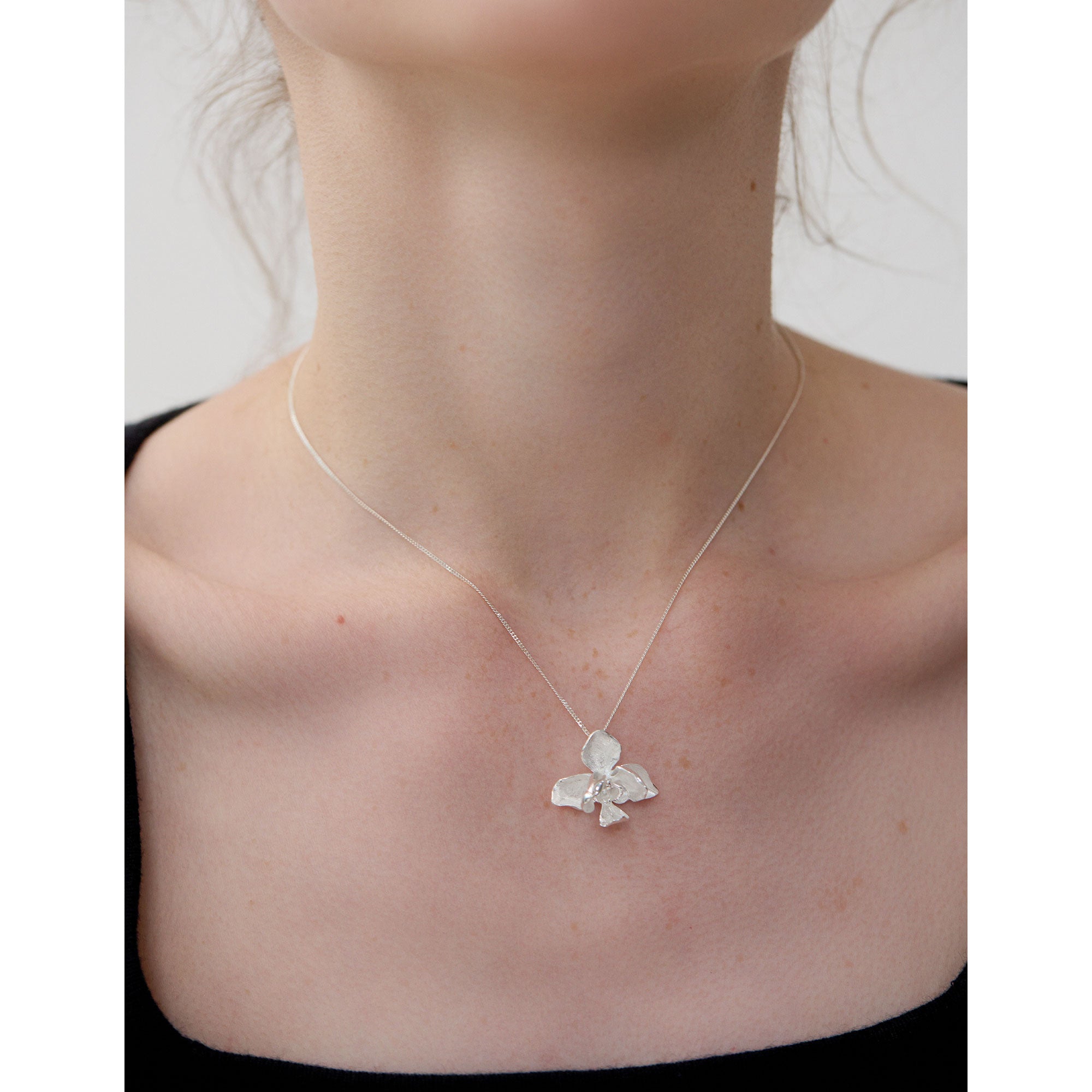 Butterfly orchid jewelry necklace close-up