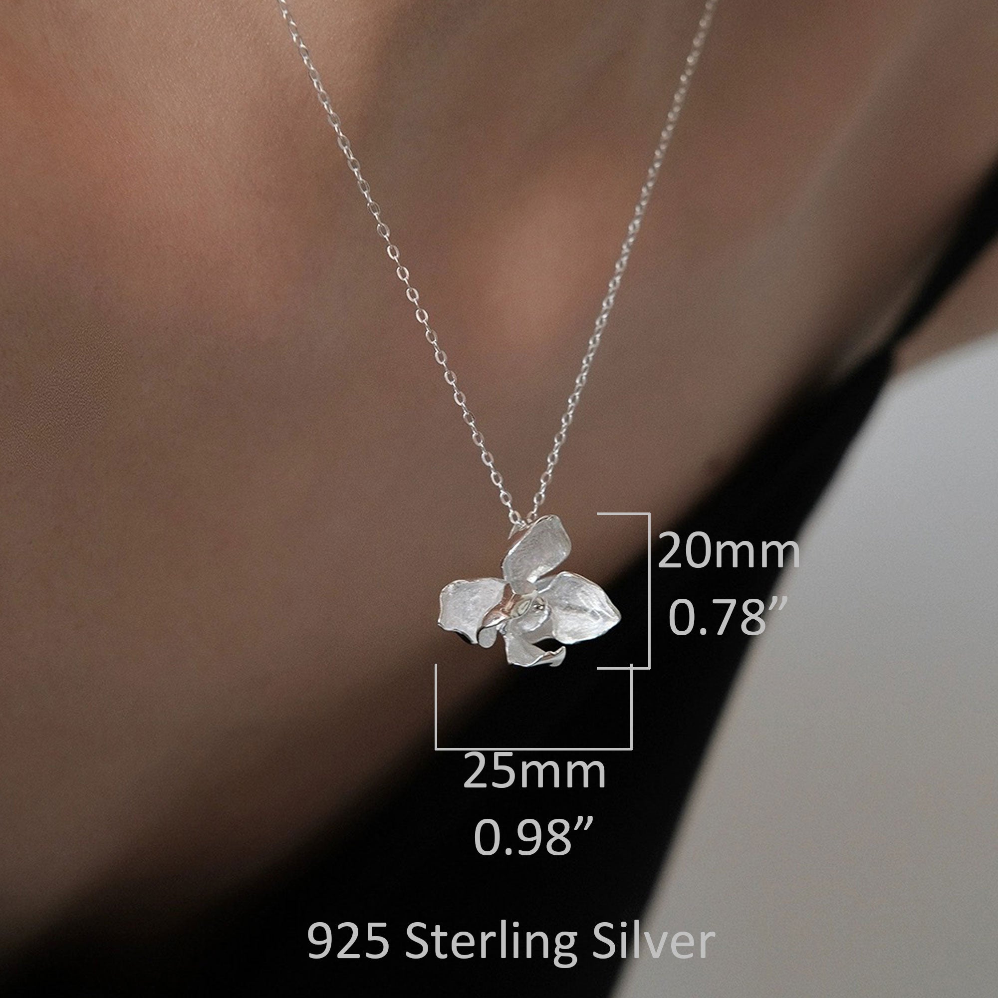 Butterfly orchid necklace displayed on neutral background