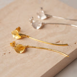 Calla lily drop earrings displayed as a pair