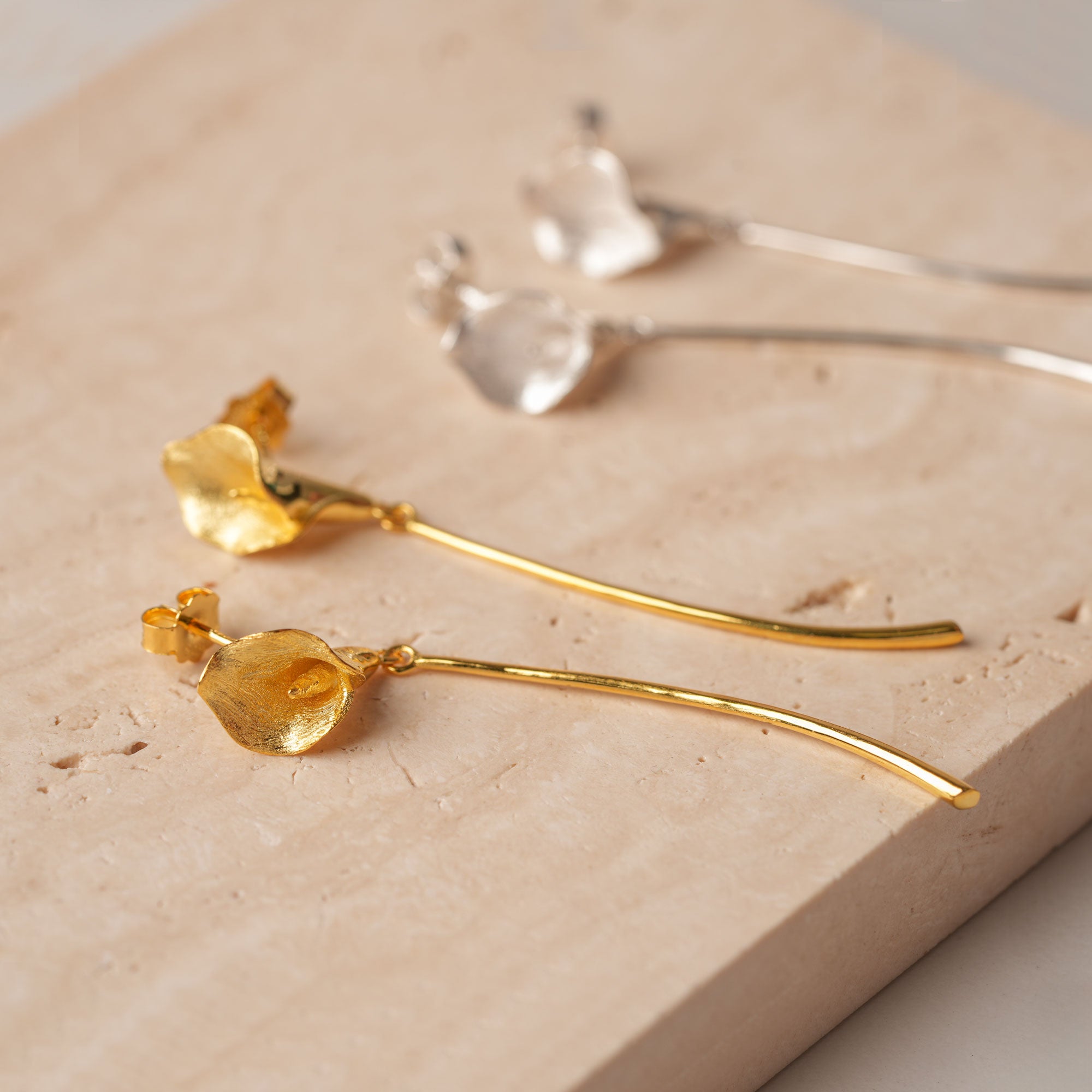 Calla lily drop earrings displayed as a pair