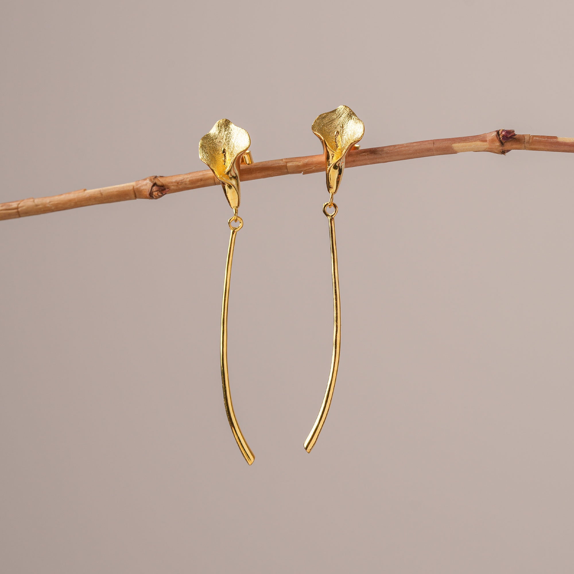 Gold calla lily earrings close-up