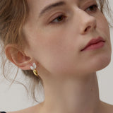 Carrot earrings on neutral product background
