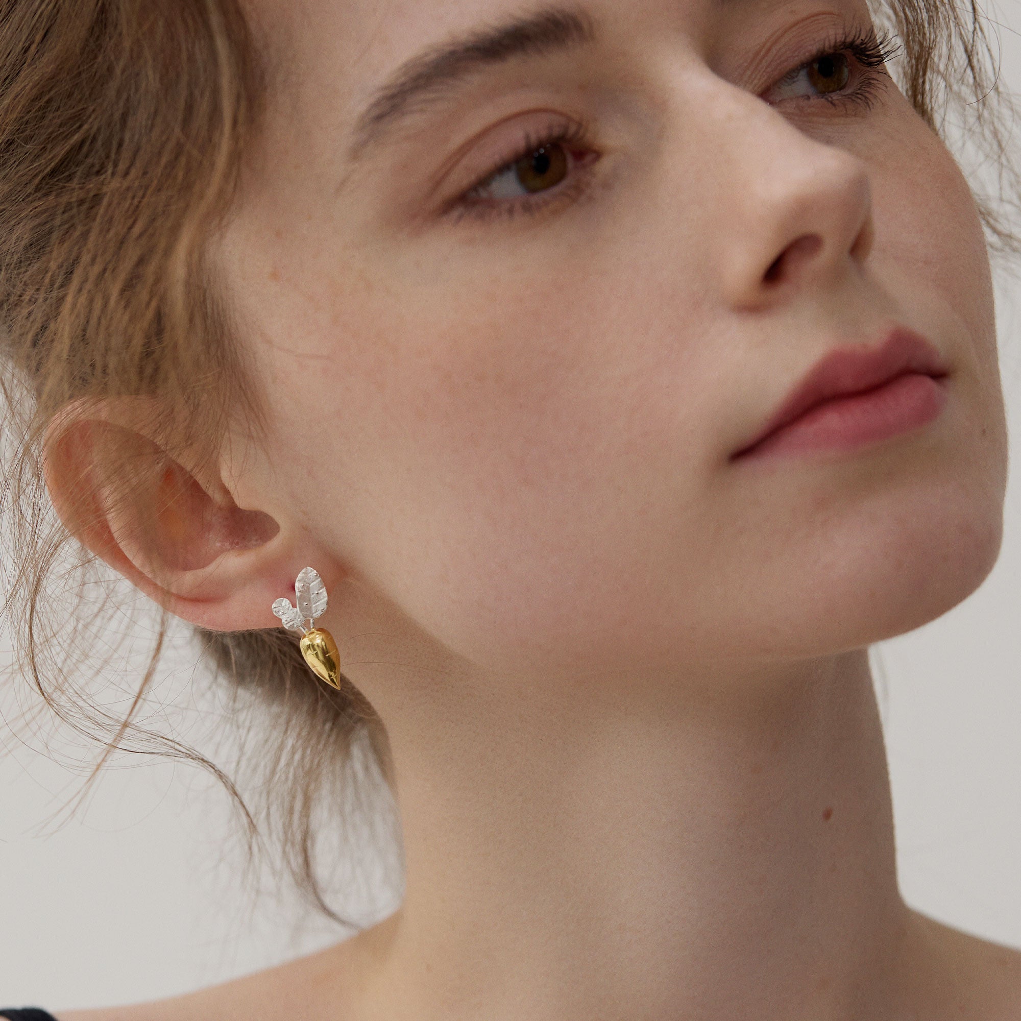 Carrot earrings on neutral product background