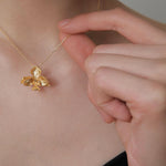 Chic gold floral jewelry with orchid pendant