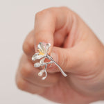 Delicate silver freesia brooch with pearl detail