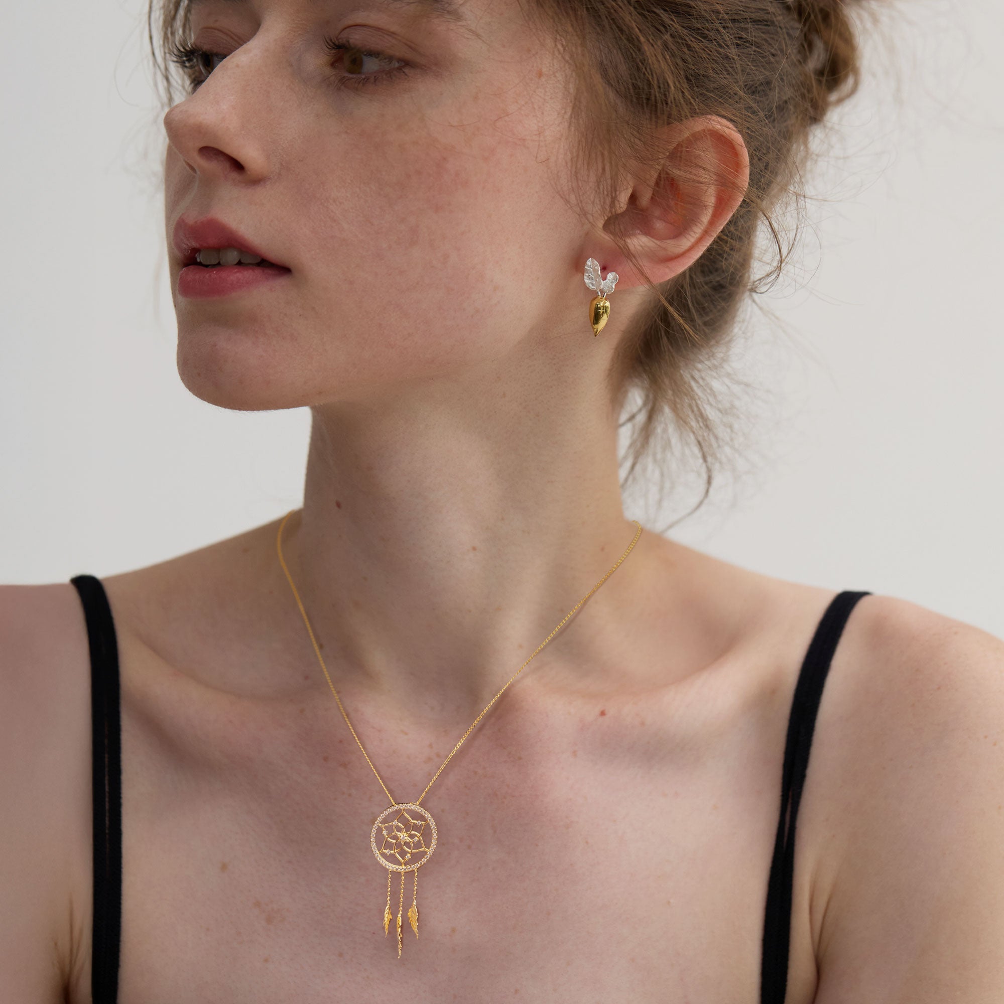 Dreamcatcher necklace displayed on neutral background