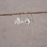 Elegant orchid drop earrings with floral petal design