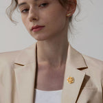 Flower brooch displayed on neutral background