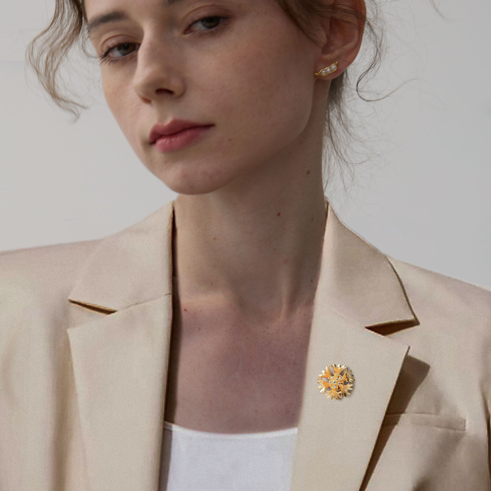 Flower brooch displayed on neutral background