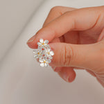Forget-me-not earrings on neutral product background