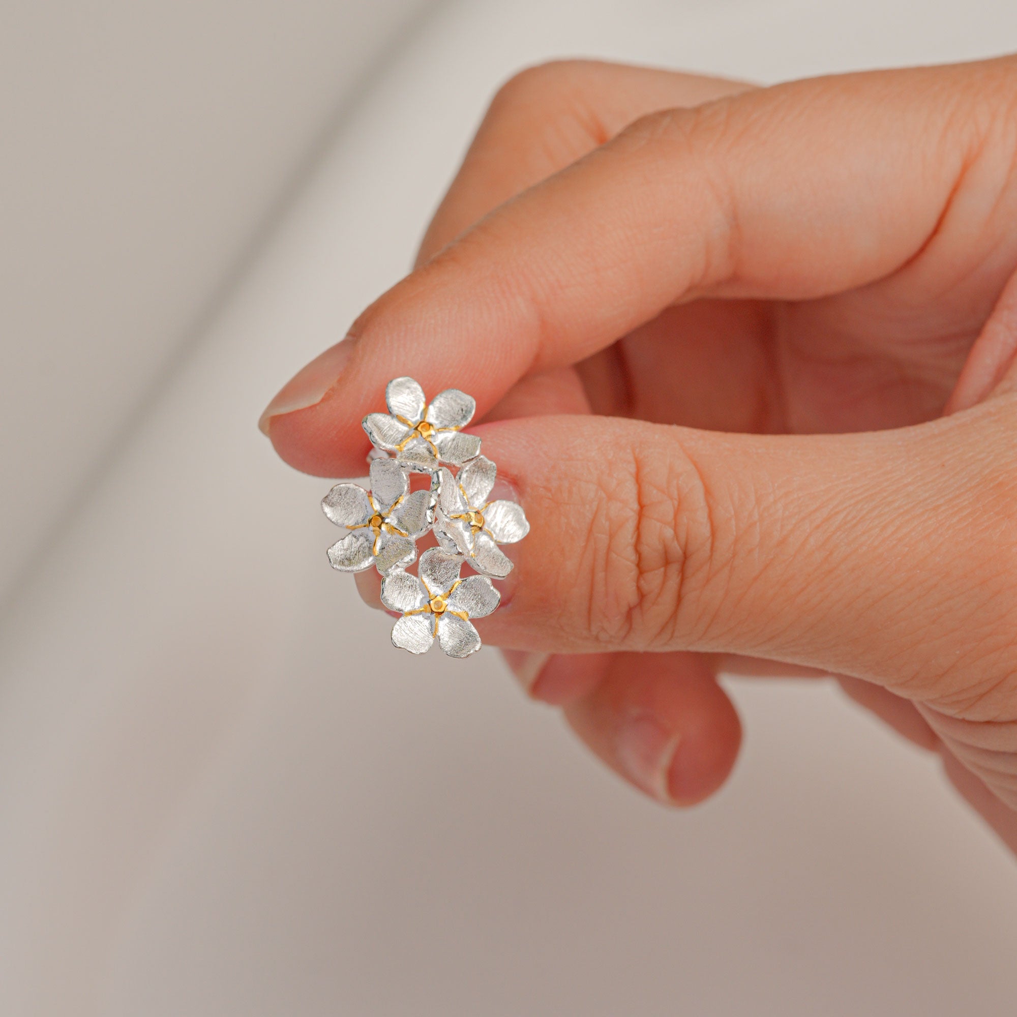 Forget-me-not earrings on neutral product background