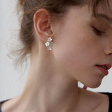 Forget-me-not floral stud earrings displayed as a pair