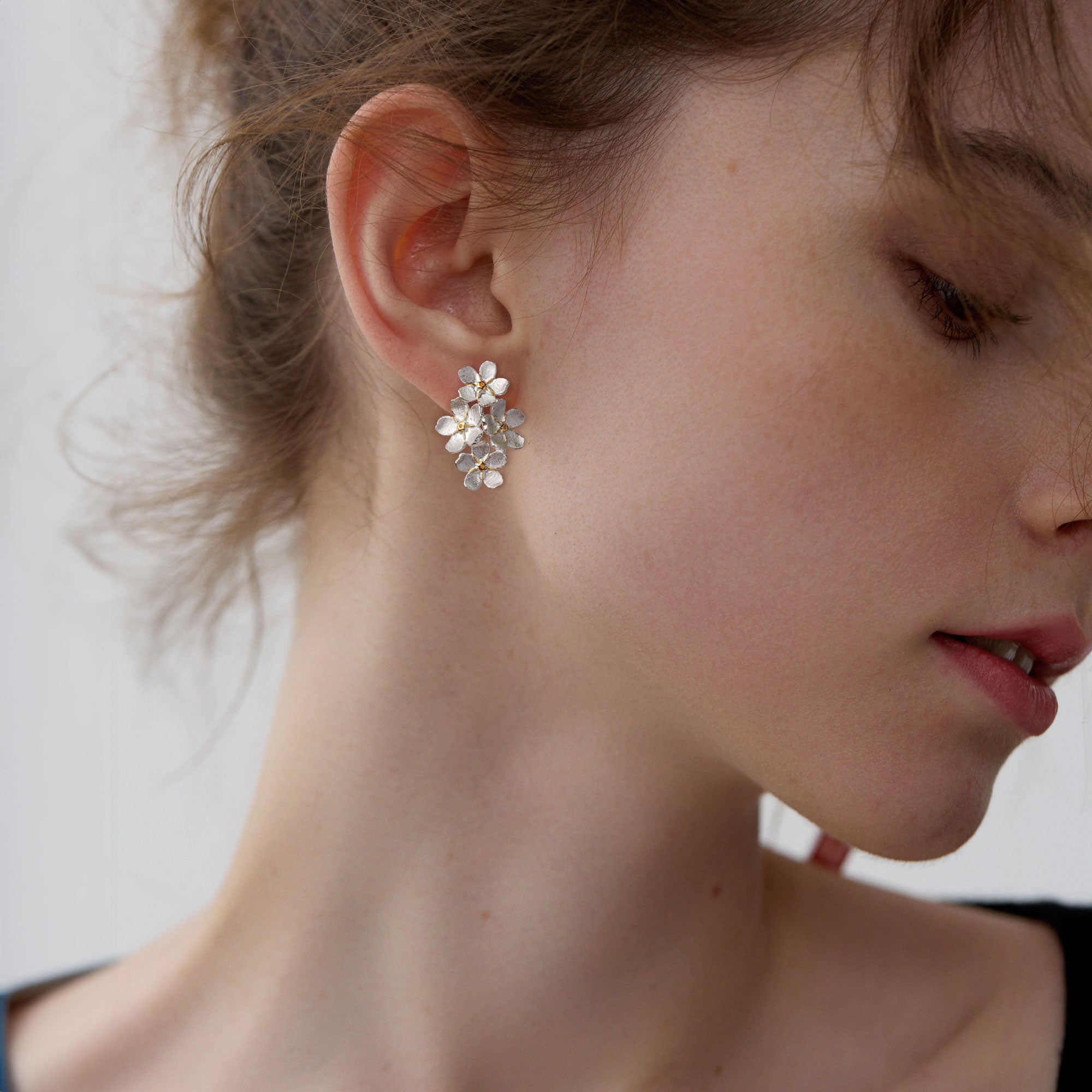 Forget-me-not floral stud earrings displayed as a pair