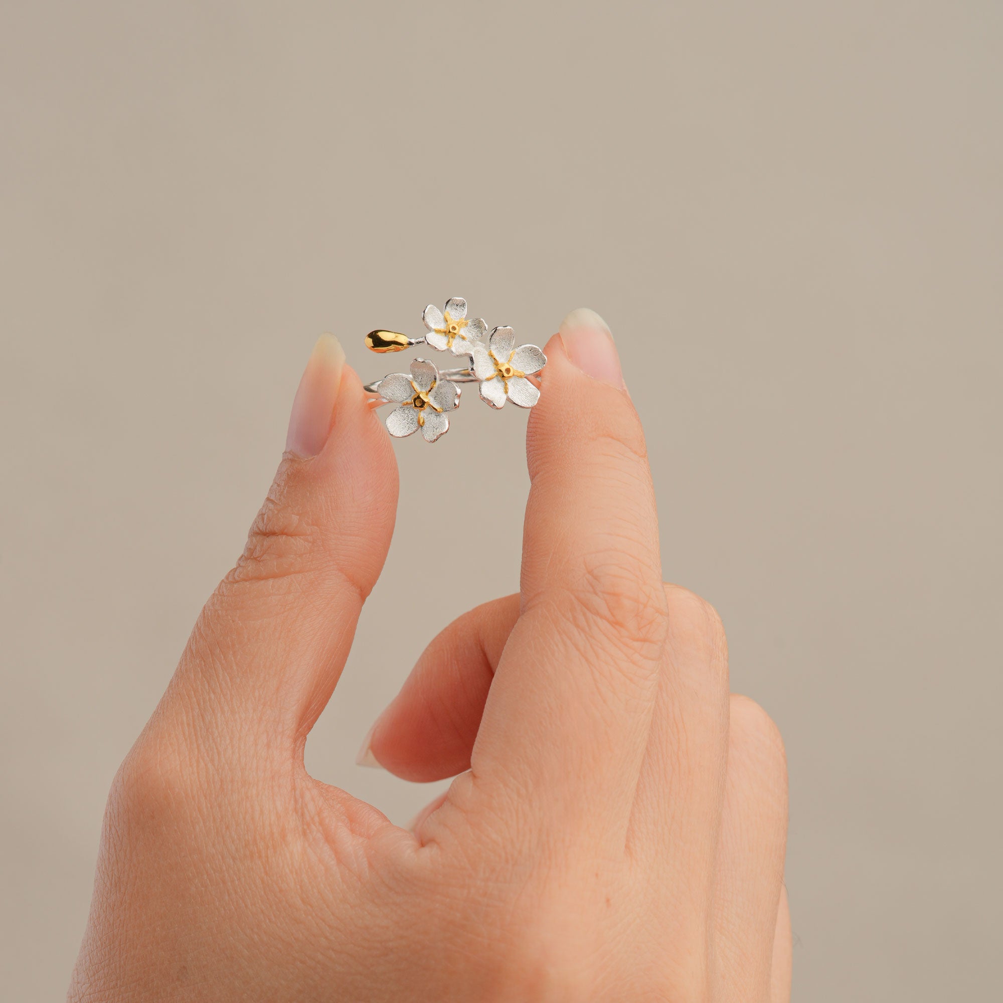 Forget-me-not flower adjustable ring displayed on neutral background