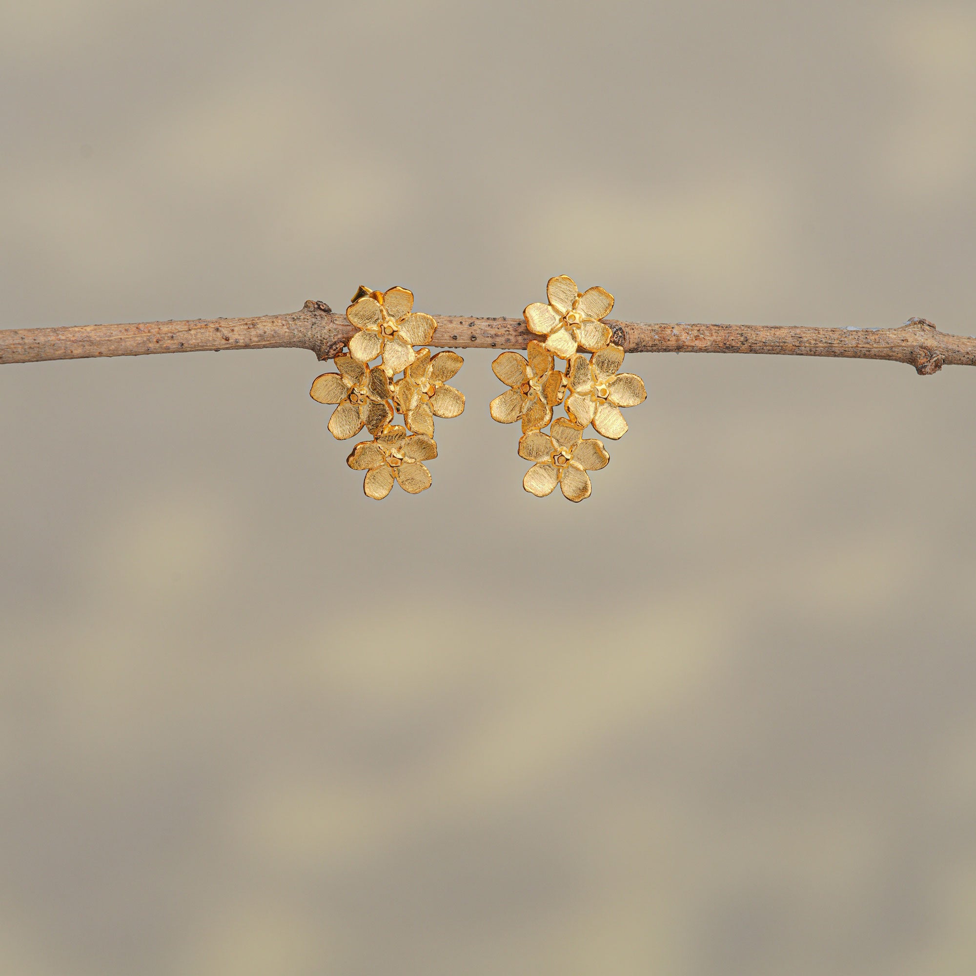 Gold forget-me-not earrings with small flower design