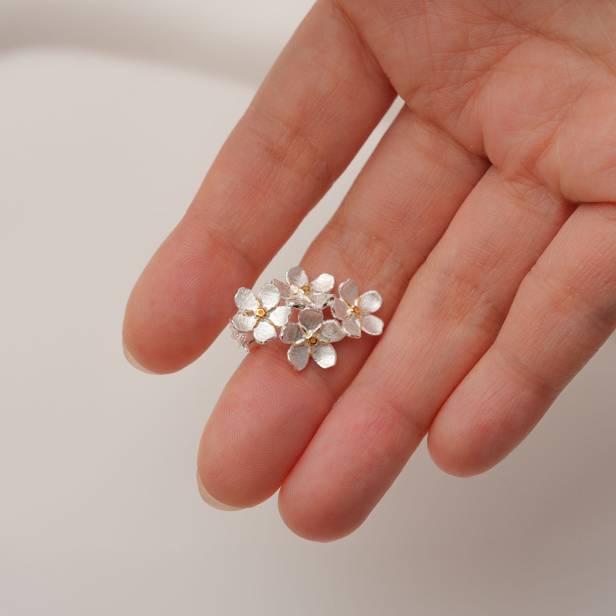 Forget-me-not stud earrings showing handmade details