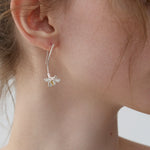 Freesia flower earrings displayed as a pair