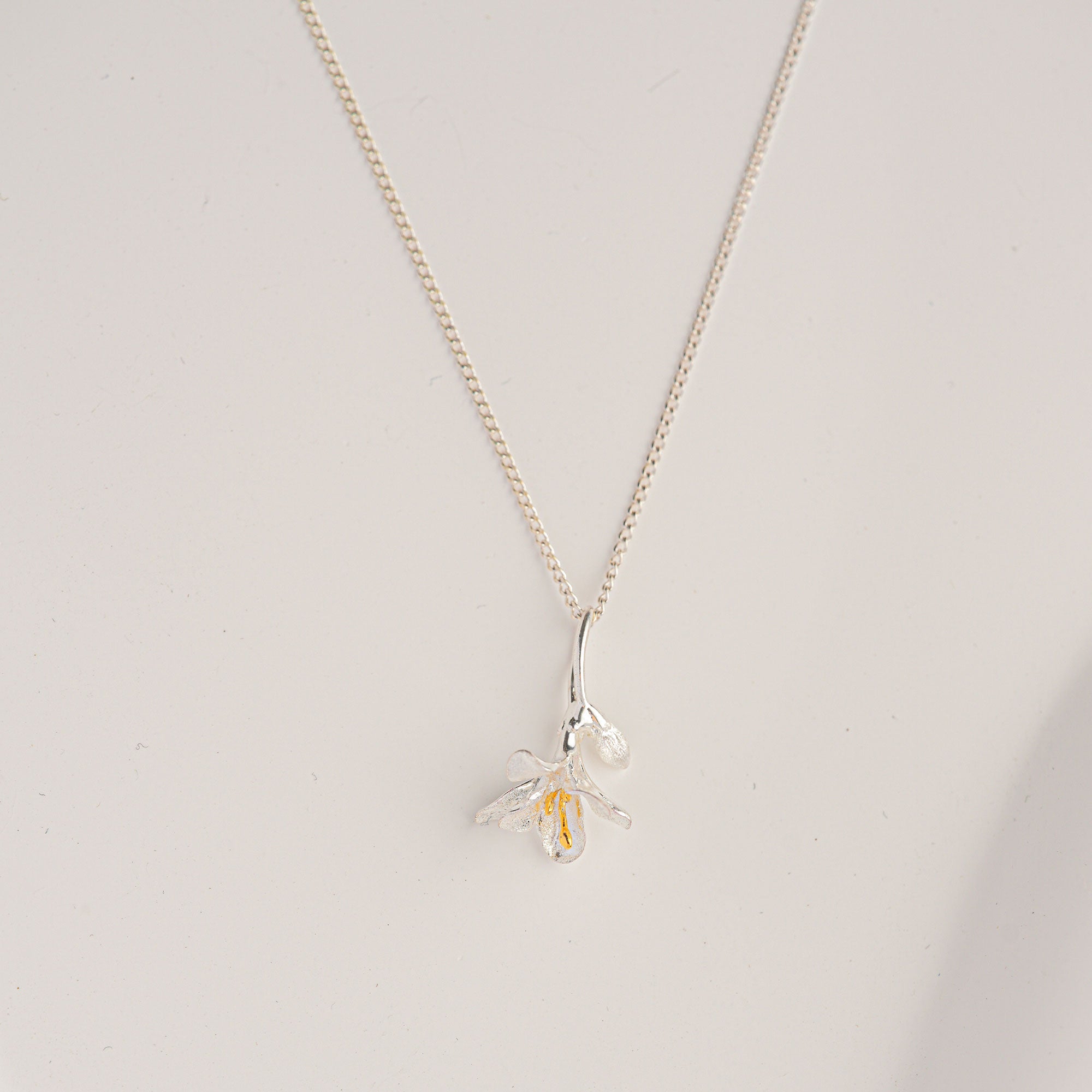 Freesia necklace displayed on neutral background