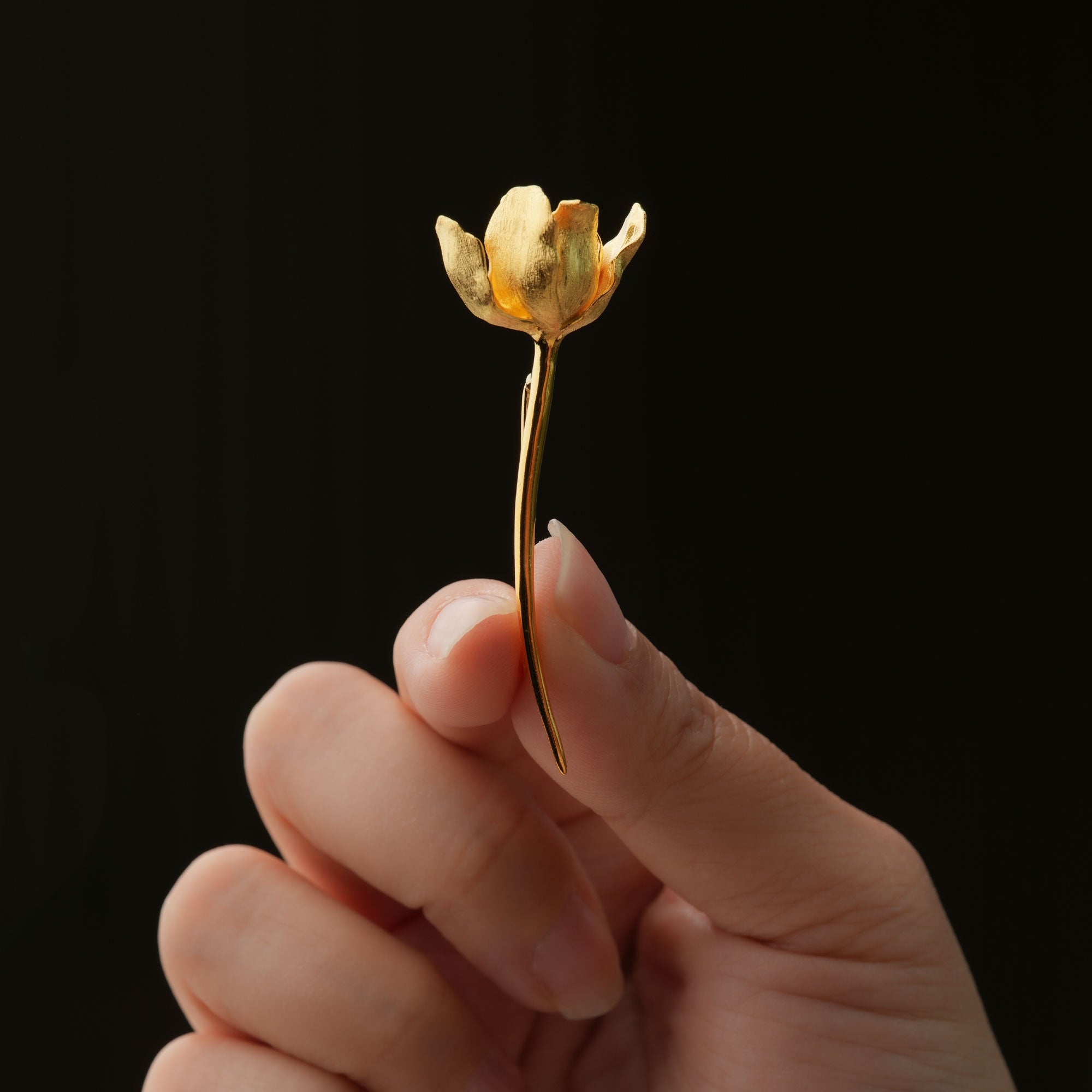 Gold tulip flower pin close-up