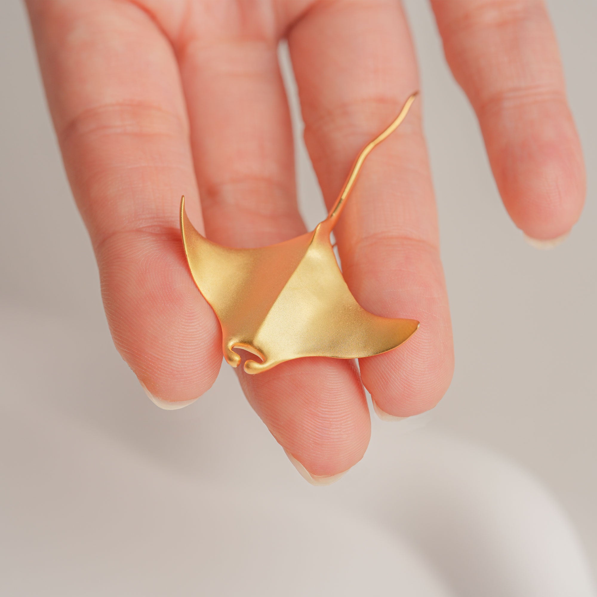 Graceful sea creature pin with manta ray shape