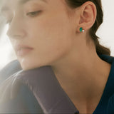 Model wearing Still Lake green resin pearl earrings