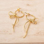 Lightweight knot earrings on neutral background