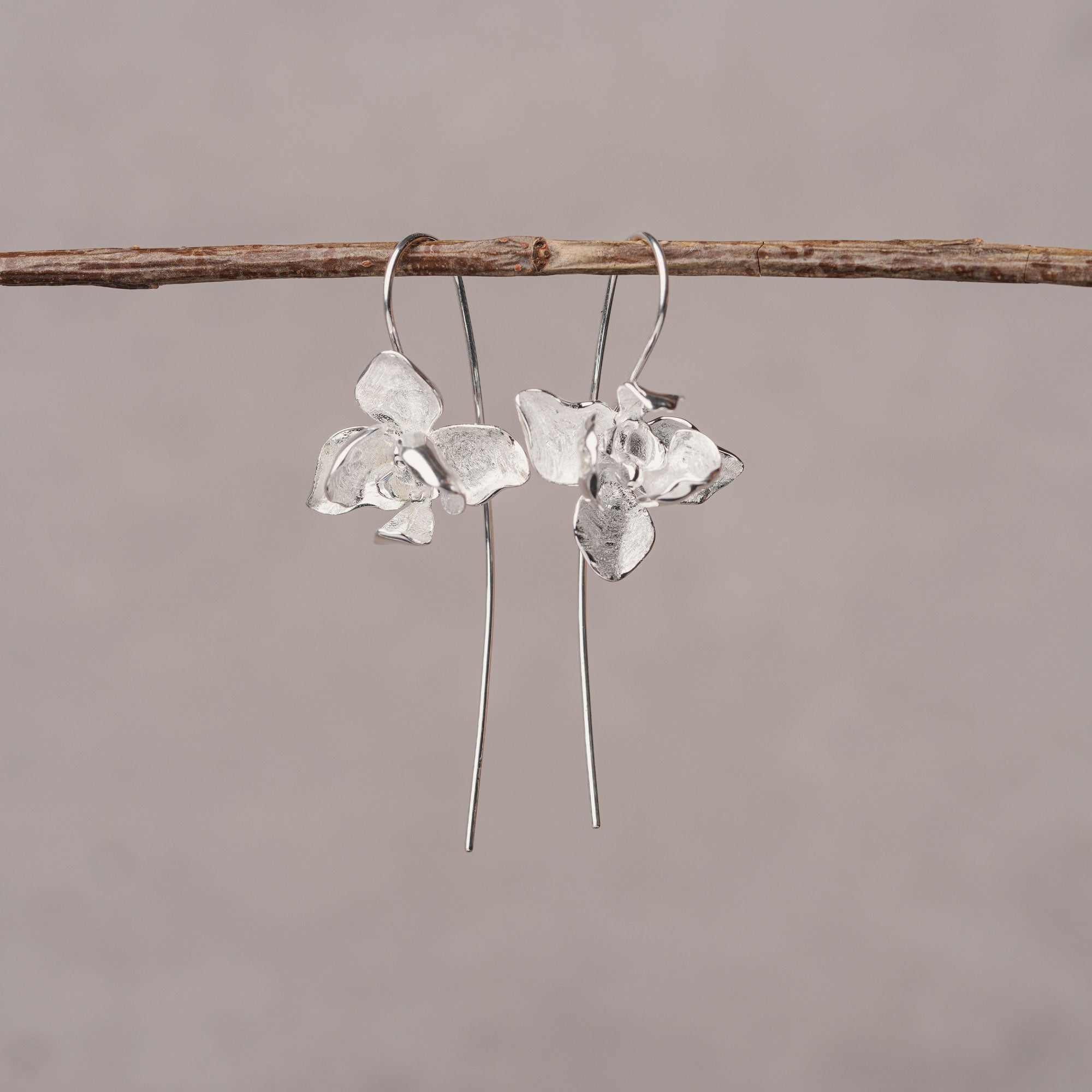 Nature inspired orchid earrings displayed as a pair