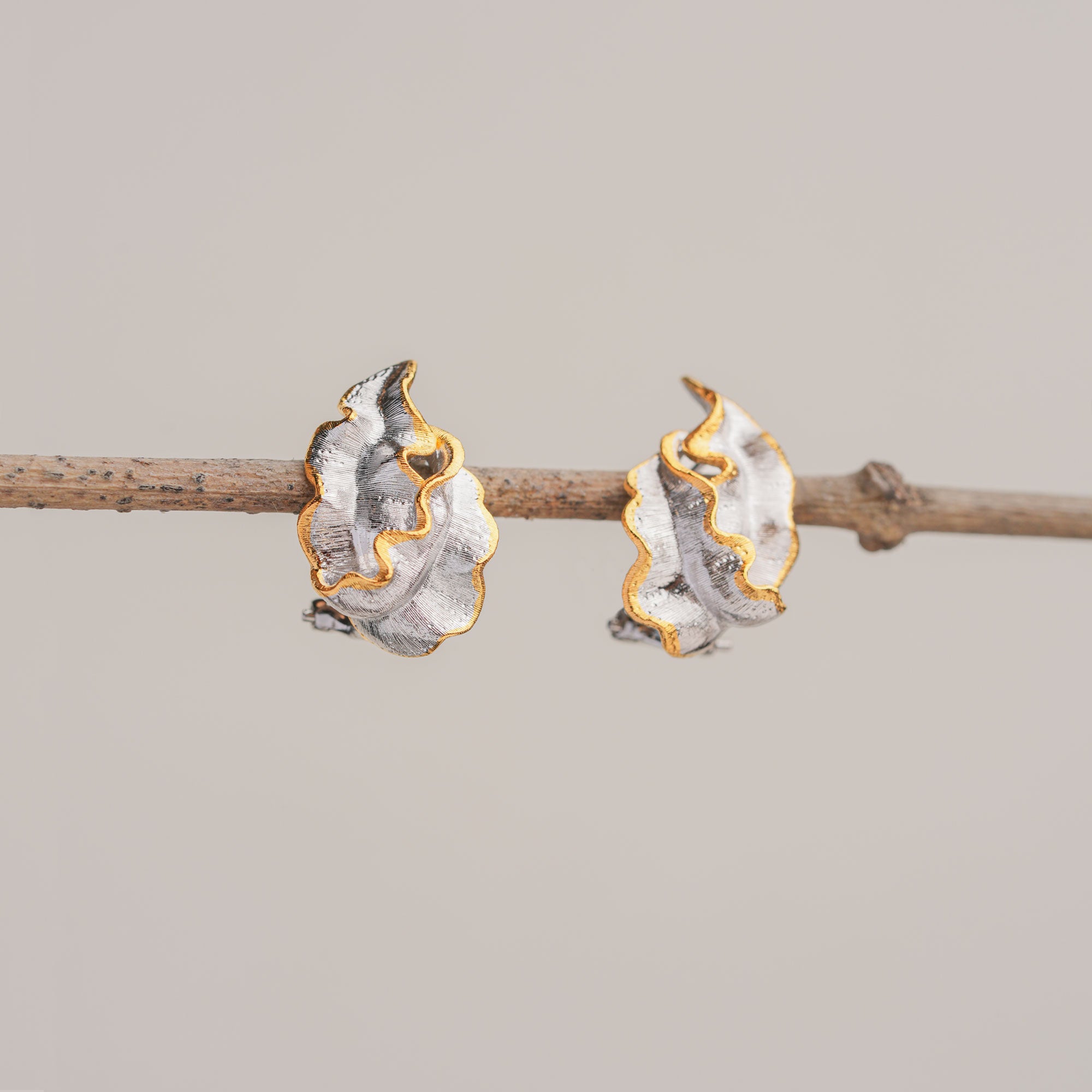 Nature inspired sea grass earrings in sterling silver and gold, sculptural artisan design for calm everyday elegance