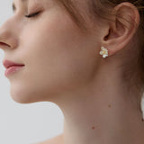 Peach blossom flower earrings on neutral background