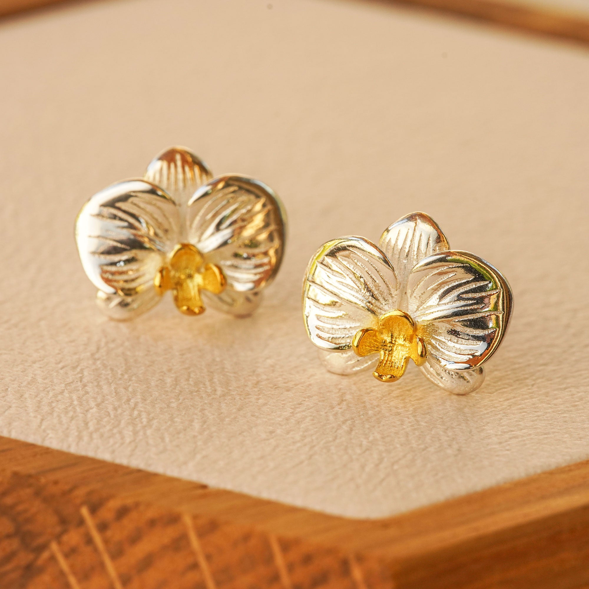 Phalaenopsis orchid earrings displayed as a pair
