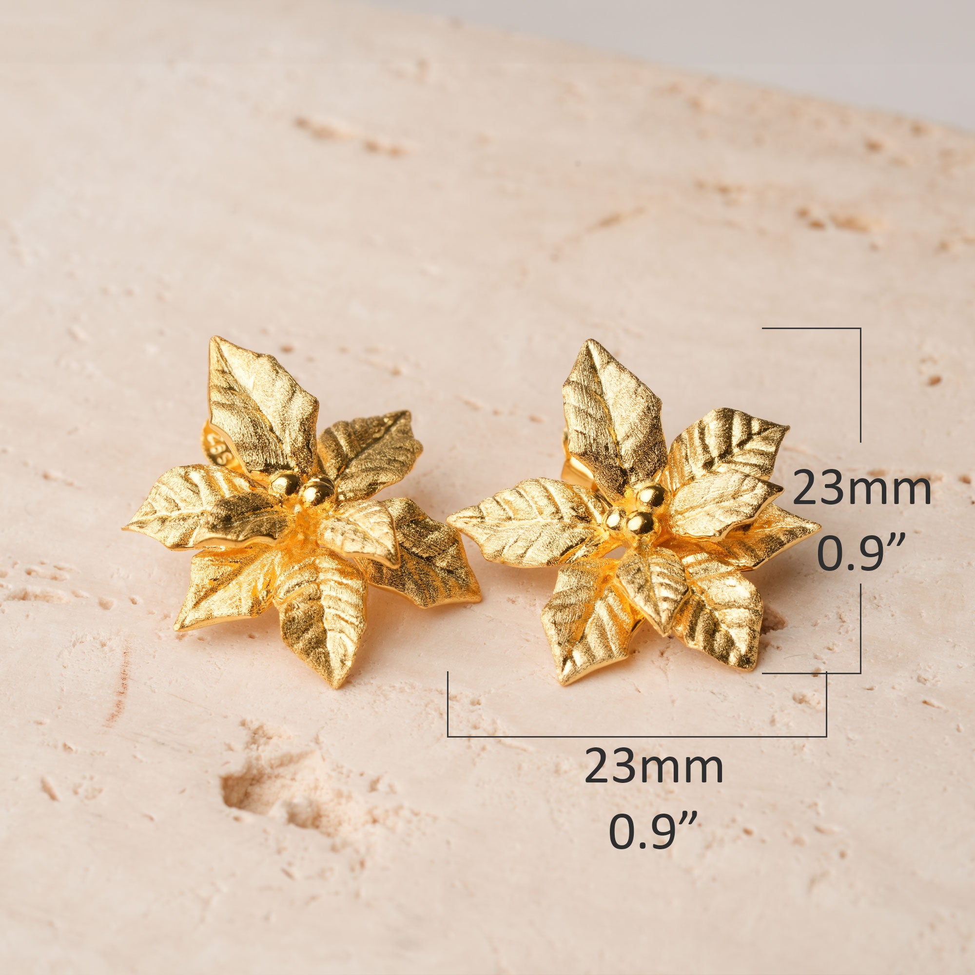 Poinsettia earrings displayed as a pair