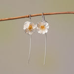 Poppy drop earrings in silver with floral design