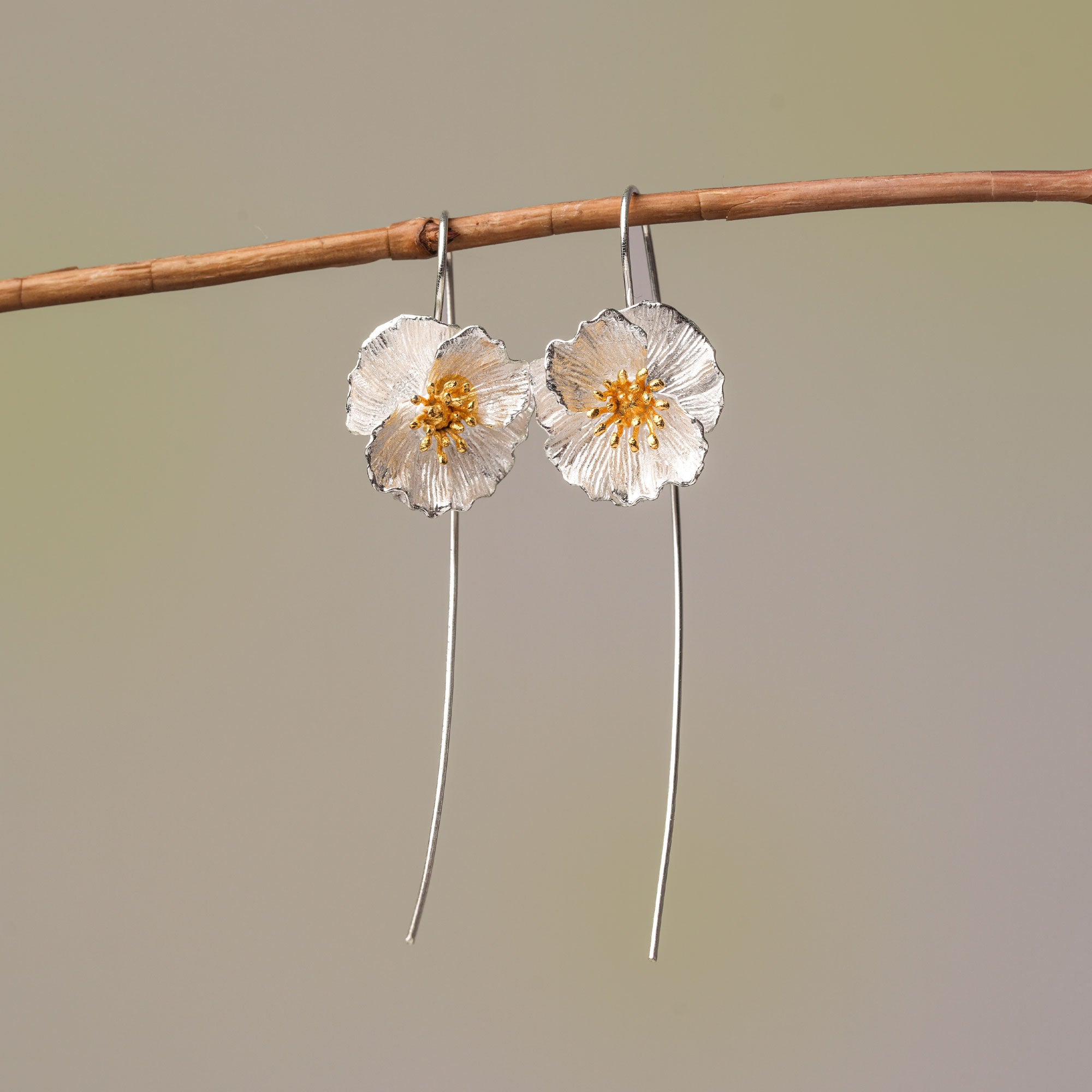 Poppy drop earrings in silver with floral design