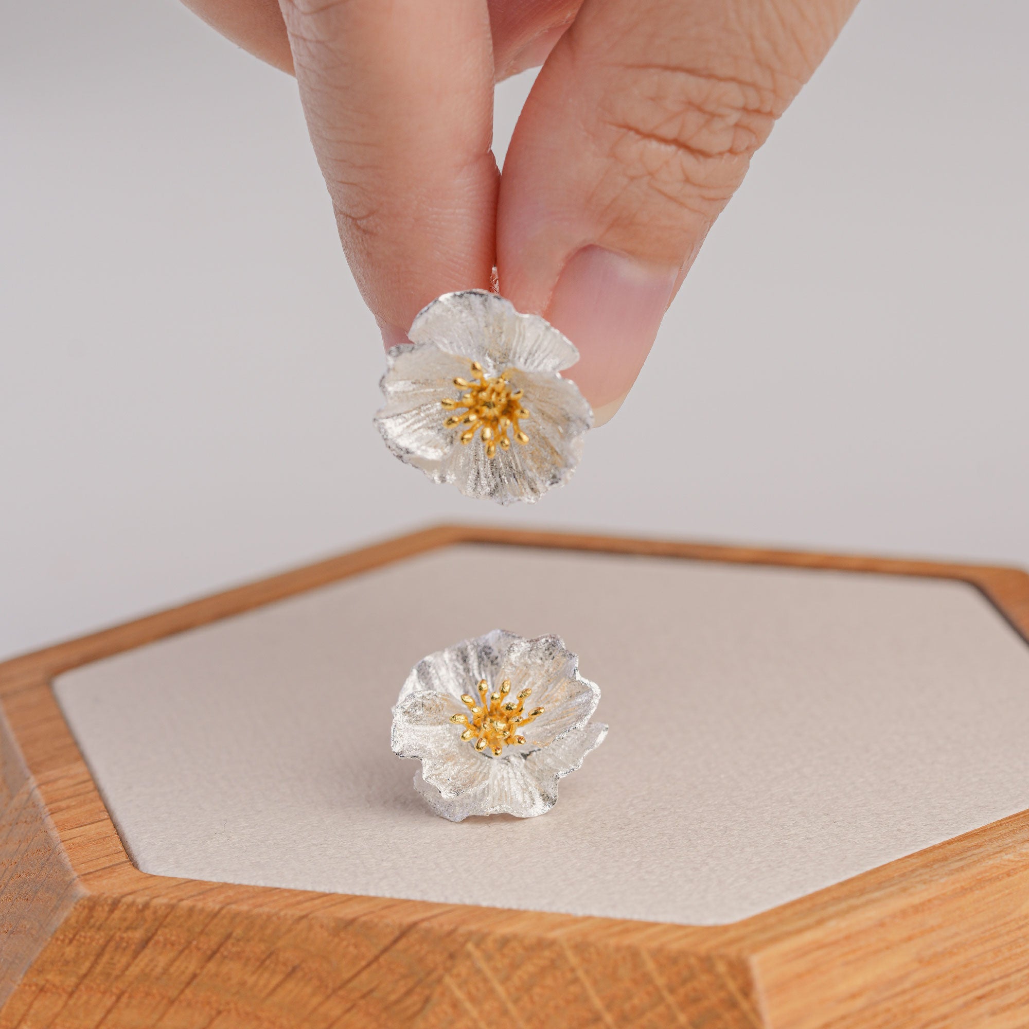 Poppy flower stud earrings displayed as a pair