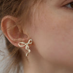 Ribbon bow earrings displayed as a pair