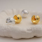 Rose earring displayed on neutral background