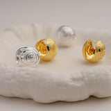 Rose earring displayed on neutral background