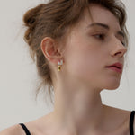 Side view of carrot silver earrings