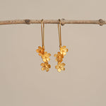 Silver cherry blossom flower earrings close-up