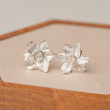 Silver daffodils flower stud earrings close-up