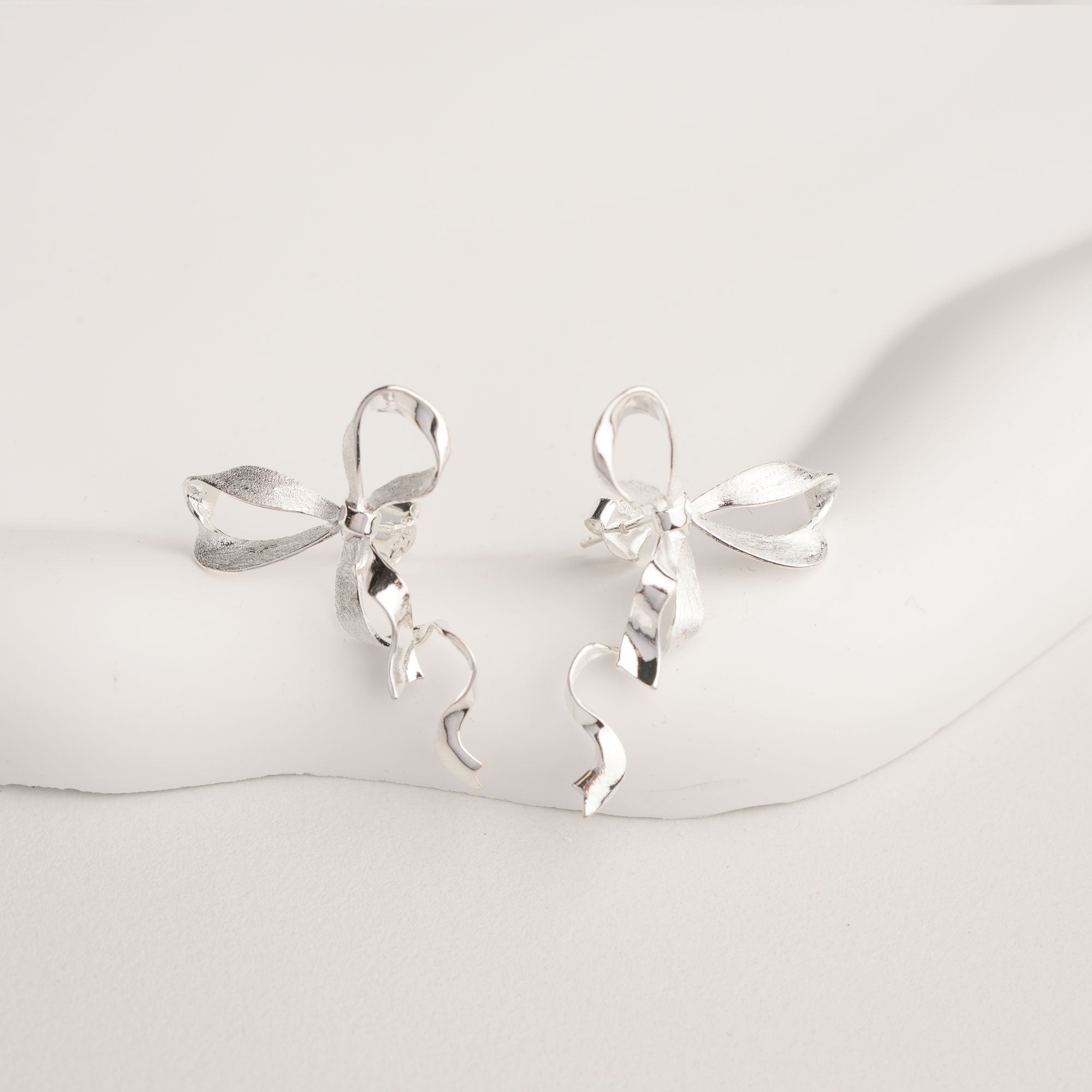 Silver ribbon bow knot earrings