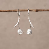 Silver tulip flower huggie earrings