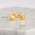 Stone stud earrings on neutral product background