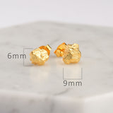 Stone stud earrings on neutral product background
