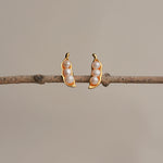 Three peas in a pod pearl earrings showing handmade details