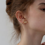 Three peas in a pod earrings displayed as a pair